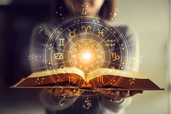 woman-holding-astrology-book-astrological-600nw-2151114189